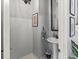 Elegant powder room with pedestal sink, decorative mirror, and stylish wall art at 7 Nesbit Pl, Alpharetta, GA 30022