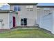 View of the backyard showing a well manicured lawn, a privacy fence, and sliding door access at 801 Old Peachtree Nw Rd # 56, Lawrenceville, GA 30043