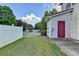 View of the backyard showing a well manicured lawn, privacy fence, and door access at 801 Old Peachtree Nw Rd # 56, Lawrenceville, GA 30043