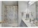 This bathroom features a large mirror, vanity, shower with tub and floral shower curtain at 801 Old Peachtree Nw Rd # 56, Lawrenceville, GA 30043