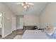 Bright bedroom features wood-look floors, a ceiling fan and vaulted ceilings at 801 Old Peachtree Nw Rd # 56, Lawrenceville, GA 30043