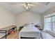 Bedroom with vaulted ceiling has a ceiling fan and a large window at 801 Old Peachtree Nw Rd # 56, Lawrenceville, GA 30043