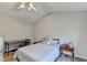 Bedroom with vaulted ceiling has wood-look floors, large window and ceiling fan at 801 Old Peachtree Nw Rd # 56, Lawrenceville, GA 30043