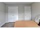Neutral bedroom features wood-look flooring and two large closets at 801 Old Peachtree Nw Rd # 56, Lawrenceville, GA 30043