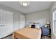 Neutral bedroom features a side table, window, and two closets at 801 Old Peachtree Nw Rd # 56, Lawrenceville, GA 30043