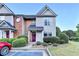 Inviting two-story townhome with neat landscaping and a freshly painted front door at 801 Old Peachtree Nw Rd # 56, Lawrenceville, GA 30043