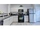 Modern kitchen featuring sleek countertops, stainless steel appliances, and ample cabinet space at 801 Old Peachtree Nw Rd # 56, Lawrenceville, GA 30043