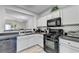 Modern kitchen featuring sleek countertops, stainless steel appliances, and ample cabinet space at 801 Old Peachtree Nw Rd # 56, Lawrenceville, GA 30043