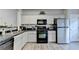 Modern kitchen featuring sleek countertops, stainless steel appliances, and ample cabinet space at 801 Old Peachtree Nw Rd # 56, Lawrenceville, GA 30043
