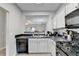 Well-lit kitchen featuring modern appliances and a convenient passthrough to the dining area at 801 Old Peachtree Nw Rd # 56, Lawrenceville, GA 30043