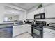 Well-lit kitchen featuring modern appliances and a convenient passthrough to the dining area at 801 Old Peachtree Nw Rd # 56, Lawrenceville, GA 30043