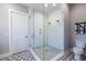 Modern bathroom with a glass enclosed shower featuring dual shower heads and patterned tile floor at 1076 Manigault Se St, Atlanta, GA 30316
