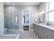 Spa-like bathroom with glass enclosed shower, stylish floor tiles, and a dual sink vanity at 1076 Manigault Se St, Atlanta, GA 30316
