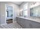 Spa-like bathroom with glass enclosed shower, stylish floor tiles, and a dual sink vanity at 1076 Manigault Se St, Atlanta, GA 30316