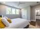 Bright bedroom features a large window, hardwood floors, neutral paint and access to the ensuite bathroom at 1076 Manigault Se St, Atlanta, GA 30316