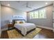 Bright bedroom with a large window, gray bed frame, hardwood floors and neutral walls at 1076 Manigault Se St, Atlanta, GA 30316