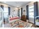Bright bedroom with a bed, colorful rug, lots of windows, and charming decor at 1076 Manigault Se St, Atlanta, GA 30316
