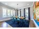 Elegant dining room featuring a modern chandelier, large windows, and an artistic accent wall at 1076 Manigault Se St, Atlanta, GA 30316