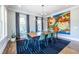 Bright dining area with a modern light fixture, ample windows, and a colorful accent wall at 1076 Manigault Se St, Atlanta, GA 30316