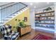 Entryway features wooden accent wall, hardwood floors, floating shelves, and stairs with iron railing at 1076 Manigault Se St, Atlanta, GA 30316