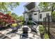 Exterior view of the home featuring an outdoor seating area, staircase, and balconies at 1076 Manigault Se St, Atlanta, GA 30316