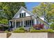 Stunning two-story home featuring a classic design, inviting porch and lush landscaping at 1076 Manigault Se St, Atlanta, GA 30316