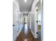 Long hallway features dark wood floors, white trim and neutral paint at 1076 Manigault Se St, Atlanta, GA 30316