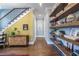Inviting hallway featuring hardwood floors, floating shelves, and stairs with iron railing at 1076 Manigault Se St, Atlanta, GA 30316