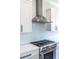 Close up of a gourmet kitchen with a stainless steel range hood and backsplash at 1076 Manigault Se St, Atlanta, GA 30316