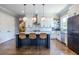 Stylish kitchen featuring white cabinets, a black island, and stainless steel appliances at 1076 Manigault Se St, Atlanta, GA 30316