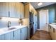Modern laundry room featuring wooden cabinets, stacked washer/dryer, and wooden floors at 1076 Manigault Se St, Atlanta, GA 30316