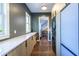 View of laundry room with modern cabinets, stacked washer/dryer, and hallway entry at 1076 Manigault Se St, Atlanta, GA 30316