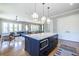 Spacious open floor plan seamlessly connecting kitchen, dining, and living areas with hardwood floors and modern lighting at 1076 Manigault Se St, Atlanta, GA 30316