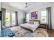 Bright bedroom with a modern ceiling fan, plush rug, ensuite access, and a private balcony at 1076 Manigault Se St, Atlanta, GA 30316