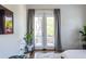 Bright bedroom with access to a private balcony, plush rug, and ample natural light at 1076 Manigault Se St, Atlanta, GA 30316