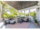 Covered porch offers a comfortable seating area with a ceiling fan, outdoor speakers, and lots of plants at 1076 Manigault Se St, Atlanta, GA 30316