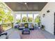 Covered porch offers a comfortable seating area with a ceiling fan, outdoor speakers, and lots of plants at 1076 Manigault Se St, Atlanta, GA 30316