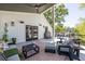 Covered porch offers a comfortable seating area with a ceiling fan, outdoor speakers, and stainless steel grill at 1076 Manigault Se St, Atlanta, GA 30316