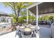Spacious porch features an outdoor kitchen with a dining area and a seating area with comfortable furniture at 1076 Manigault Se St, Atlanta, GA 30316