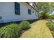 Side yard landscaped with ornamental grasses highlighting the exterior of this two-story home at 1076 Manigault Se St, Atlanta, GA 30316