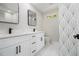 Bathroom featuring double vanity, black fixtures, and geometrically tiled shower at 1189 Gardenia Nw St, Atlanta, GA 30314