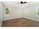 Bedroom with wood floors, tray ceilings, natural light, and white trim at 1189 Gardenia Nw St, Atlanta, GA 30314