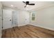 Bright bedroom featuring wood-look flooring, ceiling fan and an ensuite bathroom with stylish geometric shower tile at 1189 Gardenia Nw St, Atlanta, GA 30314