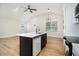 Modern kitchen with white countertops, black island, stainless steel appliances, and wood floors at 1189 Gardenia Nw St, Atlanta, GA 30314