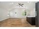 Open-concept area with wood floors, high ceilings, and a modern kitchen island at 1189 Gardenia Nw St, Atlanta, GA 30314