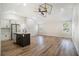 Open-concept area with wood floors, high ceilings, modern kitchen island, and large windows at 1189 Gardenia Nw St, Atlanta, GA 30314
