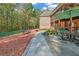 Lush backyard with covered porch, patio, seating, and brick fireplace on a well maintained property at 20 Balfour Dr, Covington, GA 30014
