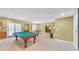 Spacious basement with pool table, doors to outside, and additional room for recreation and dining at 20 Balfour Dr, Covington, GA 30014
