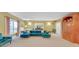 Open basement area featuring a comfortable sectional, large window, and a built-in bookshelf at 20 Balfour Dr, Covington, GA 30014