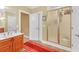 Bright bathroom featuring a shower with glass door, tiled floor, vanity and large mirror at 20 Balfour Dr, Covington, GA 30014